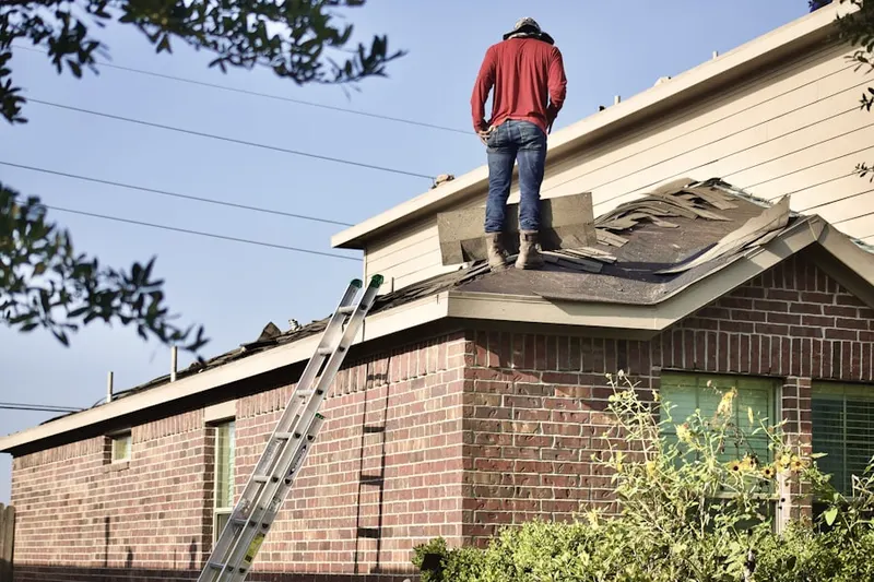 Professional roofer working on a residential roof in Mauck Farm Estates